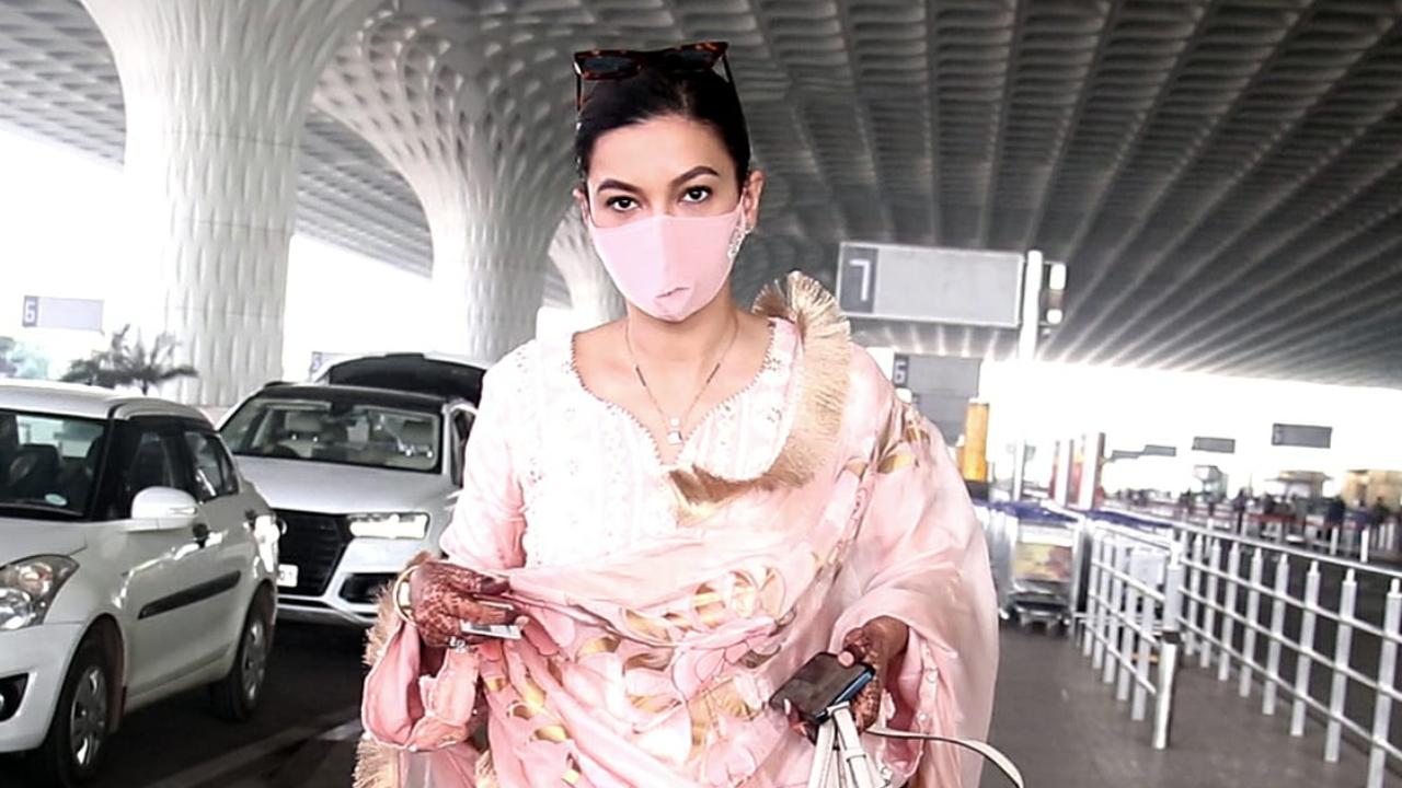 Newlywed-bride Gauahar Khan was snapped at the airport. Khan got married to beau Zaid on December 25, and the couple looked exquisite in their wedding ensembles. While Gauahar wore a heavily embroidered ivory-hued sharara along with traditional bridal jewellery, Zaid chose a sherwani and churidar in the same colour.