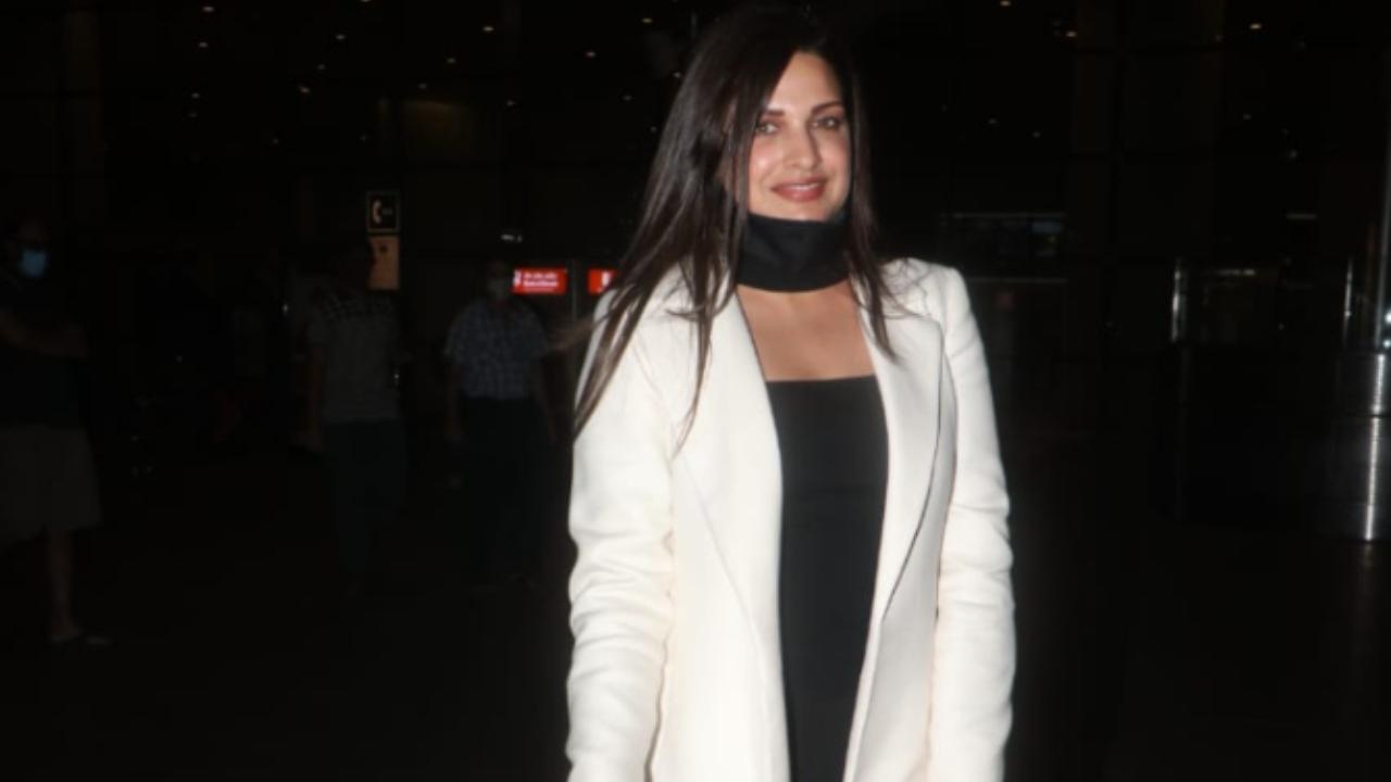 Bigg Boss 13 contestant Himanshi Khurana opted for a black dress and a white shrug as she was snapped at the airport.