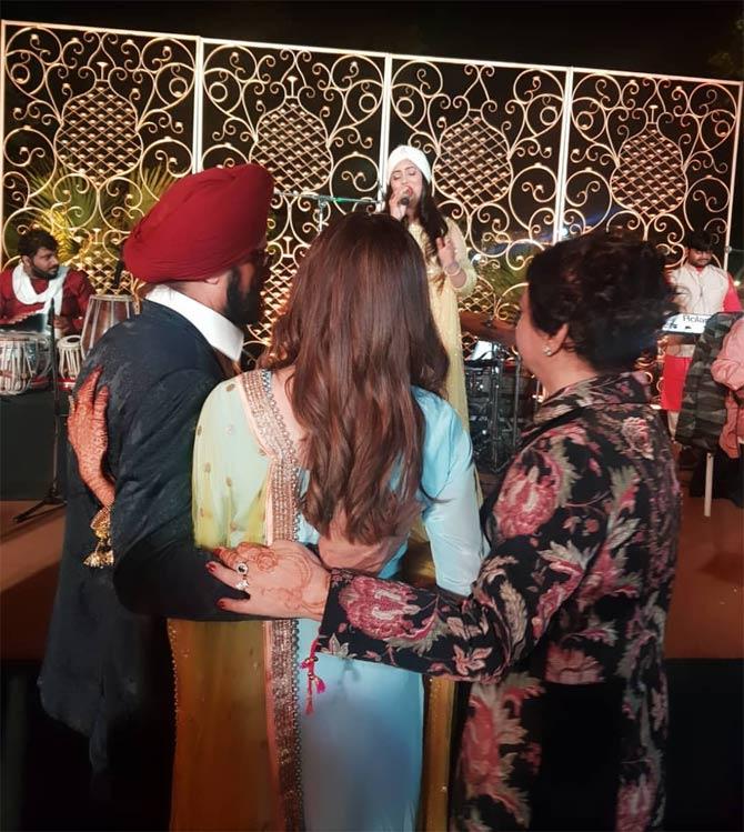 Simran Kaur Mundi, the Miss India Universe 2008, married the love of her live Gurrick Mann on January 31, 2020. The actress, who made her Bollywood debut with Jo Hum Chahein in 2011, made it official in an intimate wedding ceremony, hosted in Patiala, Punjab. All pictures/Pallav Paliwal and Sonnalli Seygall, Poppy Jabal and other Instagram account
In picture: Simran Kaur Mundi with parents as they walk her towards the sangeet ceremony.