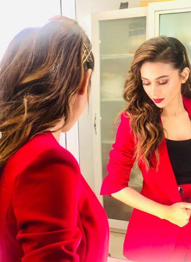 The new-age political leader looks absolutely gorgeous in a bright red-coloured suit. Mimi completed her boss lady look by opting for a red colour lipstick and eye-makeup. In the picture, Mimi can be striking a candid pose as she looks at herself in the mirror.