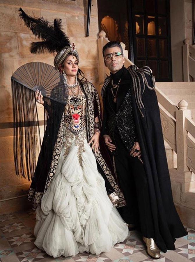 Natasha Poonawalla rocked Le Bal Oriental in the most perfect way possible. She opted for a layered ivory gown, a black jacket and a feathered headdress complete with a fan in one hand. Karan Johar, on the other hand, was dapper in a black ensemble with a blingy black blazer, a black cape, and gold shoes.