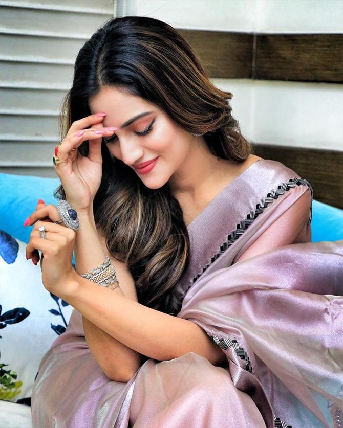 Paired with subtle makeup, minimal accessories, Nusrat Jahan left her long coloured tresses open, which gave her a natural look. Nusrat shared the pictures on Hug day and captioned it: I am in love with you. Please let me dwell in the shadow of your eyelashes!



