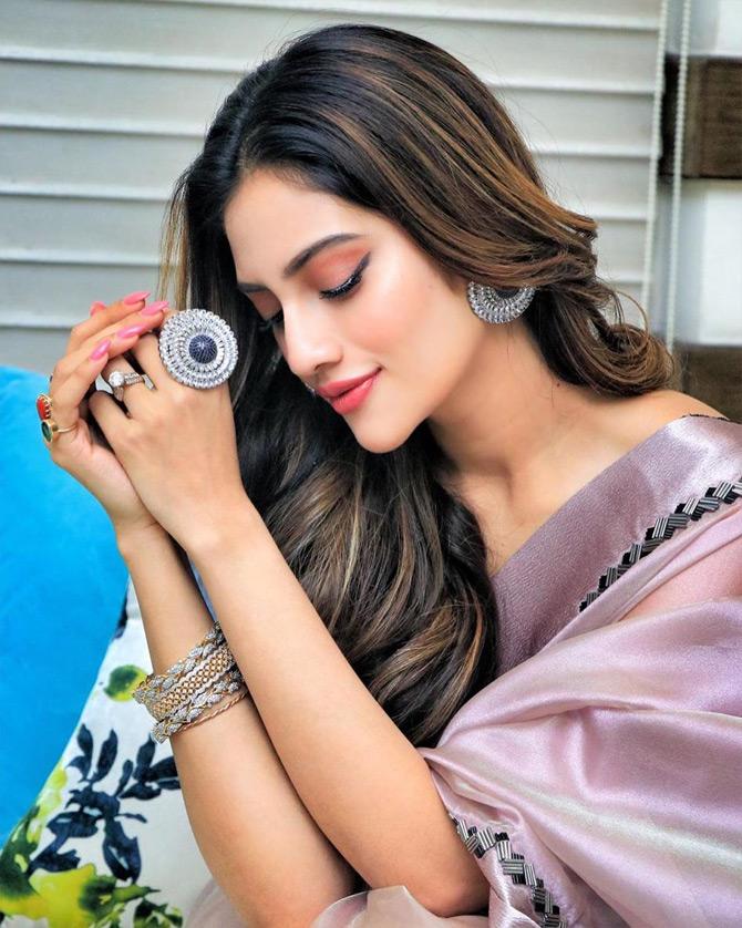In photo: Nusrat Jahan is elegance personified as she oozes confidence in a lilac saree while posing for the lenses.



