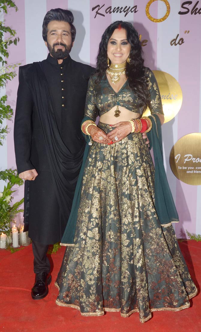 Kamya Panjabi looked pretty in her green and golden embellished designer lehenga, while husband Shalabh Dang looked dapper in his black traditional attire.