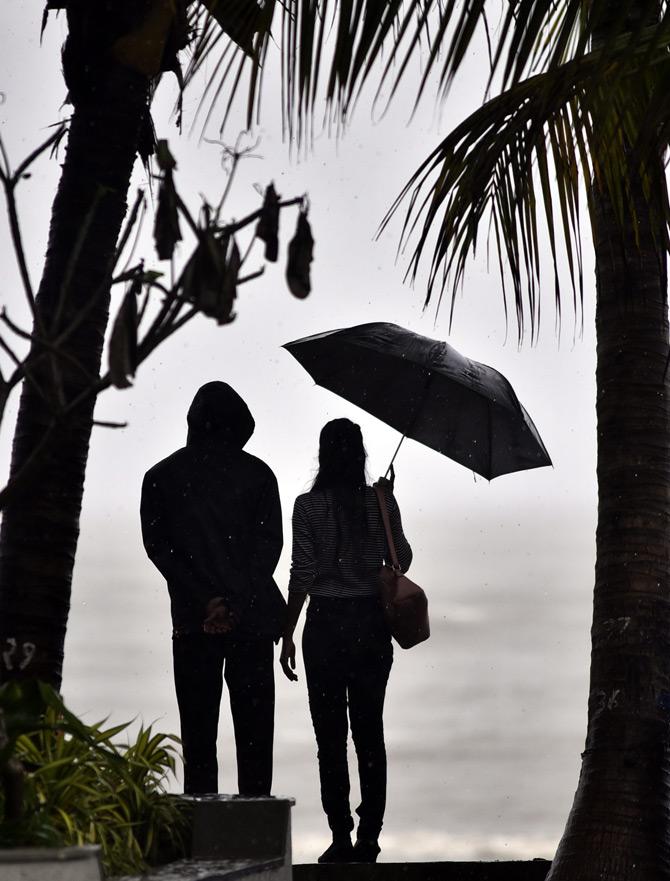 A couple enjoys the heavy showers of Mumbai monsoon as constant rains leave the city high and dry. Pic/Pradeep Dhivar



