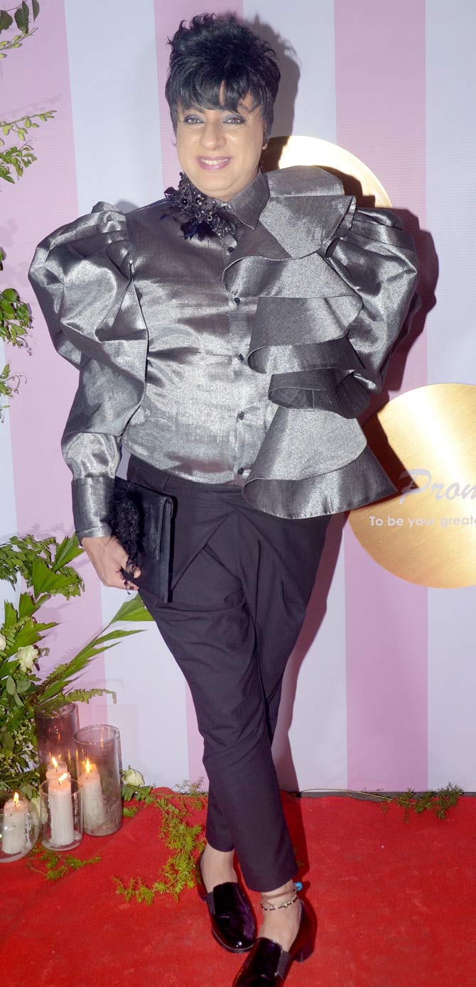 Designer Rohit Verma poses for the photographers as he arrives for Kamya Panjabi and Shalabh Dang's wedding party.