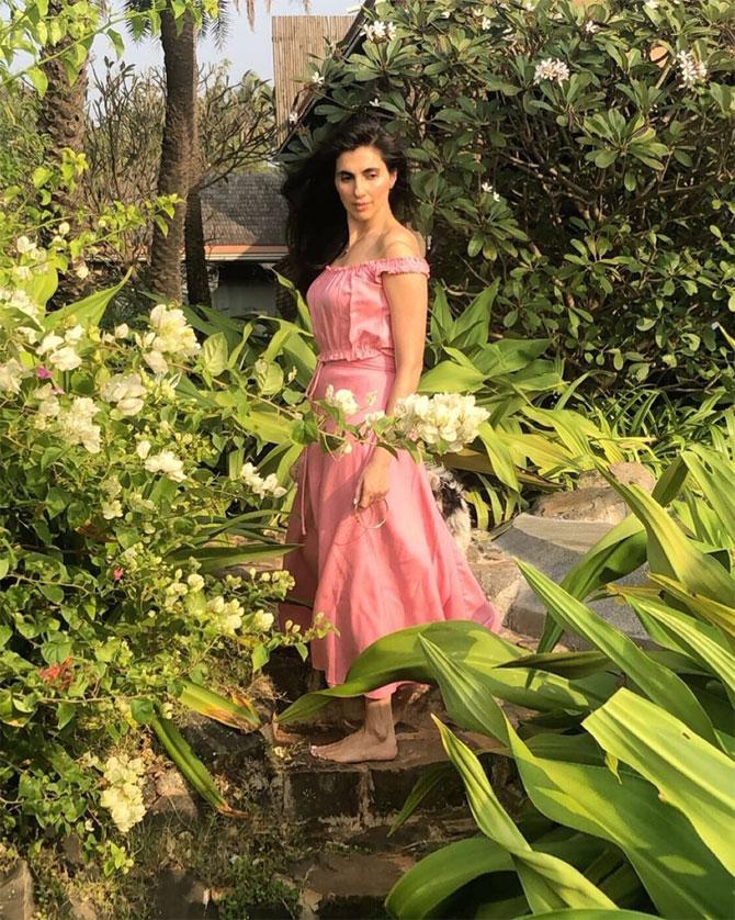She shows off her natural beauty in this peach gown amidst greenery.