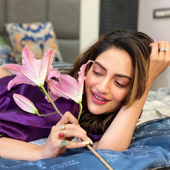 Bengali actress turned politician Nusrat Jahan, who tied the knot with her businessman beau Nikhil Jain in June 2019 celebrated her first Valentine's Day by sharing a beautiful picture of herself where she can be seen playing with a Lilly flower






