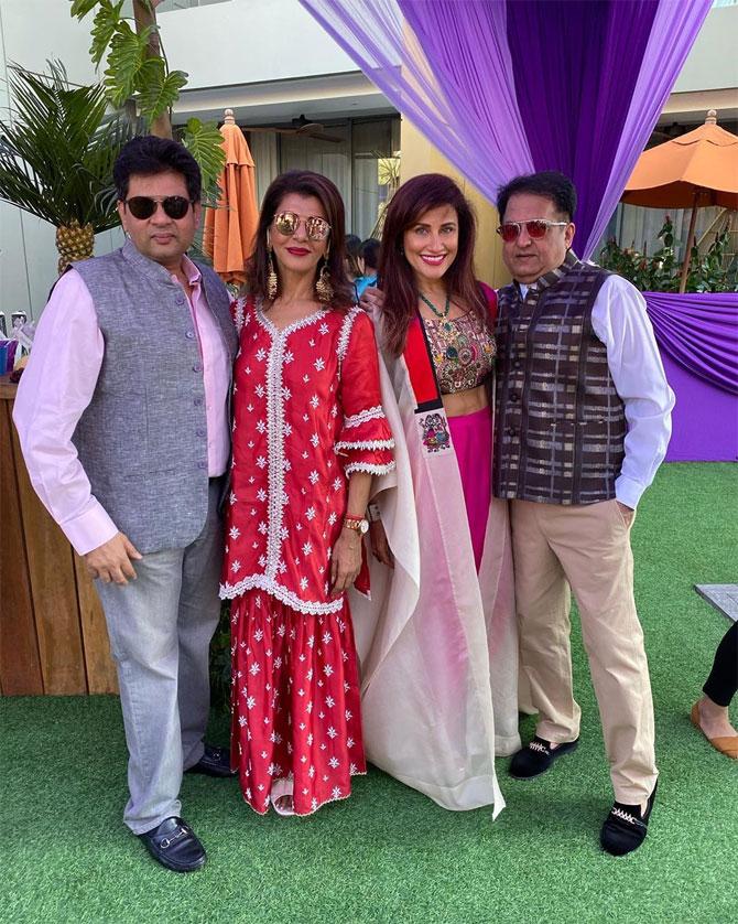 Yasmin Karachiwala looked suave in an embroidered pink blouse and pink palazzos. She paired it with a white long jacket. Her green necklace and open hair accentuated her look.
In picture: Yasmin Karachiwala with Anita Raaj and husband Minhaz Karachiwala.