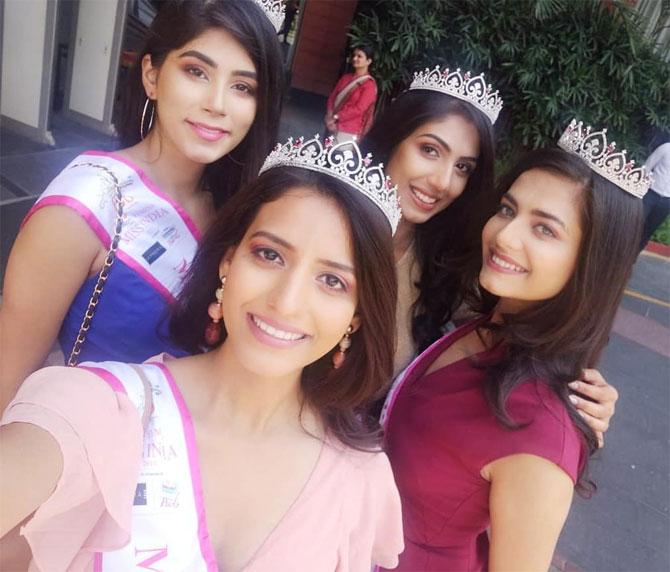 Vij looks beautiful in this red dress with her tiara, while posing with her fellow contestants. 