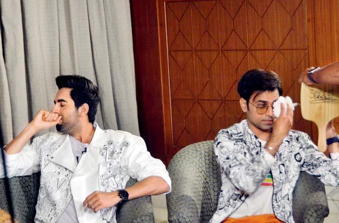 Ayushmann Khurana lets out a yawn and Jitendra Kumar gets his glasses fixed while sporting snazzy printed jackets at a Juhu five-star. Pic/Sayyed Sameer Bedi