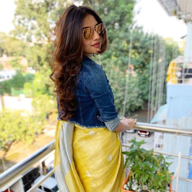 Nusrat Jahan shows how to rock a beautiful yellow saree with a denim jacket with much ease and comfort. In the picture, Nusrat Jahan looks bold and beautiful as she aces the mix and match trend by pairing a saree with denim. While sharing this picture, Nusrat captioned it: Tired yet posing...!