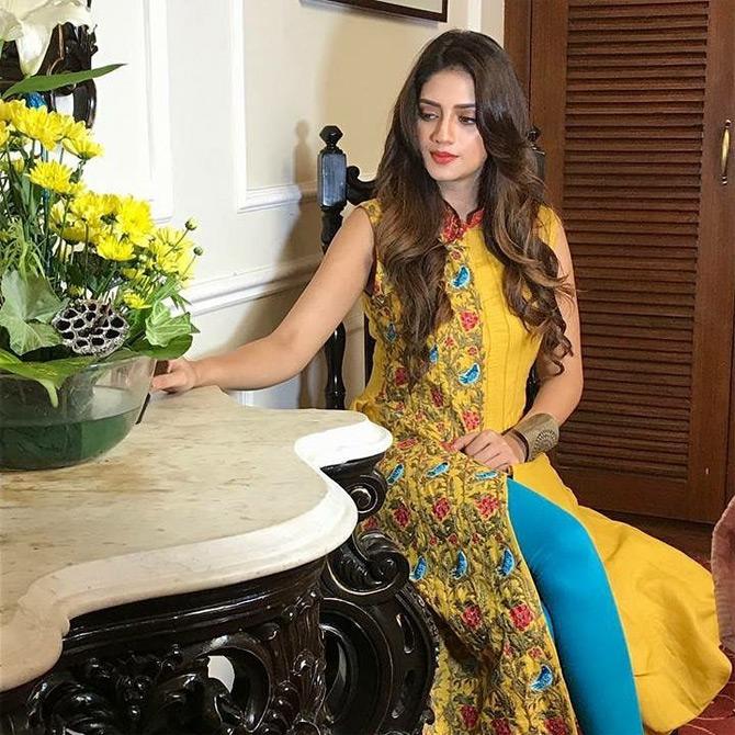 Taking her love for the colour yellow one notch higher, Nusrat Jahan can be seen posing like an ace model as she can't seem to get her eyes off of the beautiful yellow flowers. Donning a sleeveless Kurti paired with blue leggings, Nusrat captioned this one: We were born to be real... not perfect...I love my imperfections...need no validation from anyone. Always act like your wearing an invisible crown...!