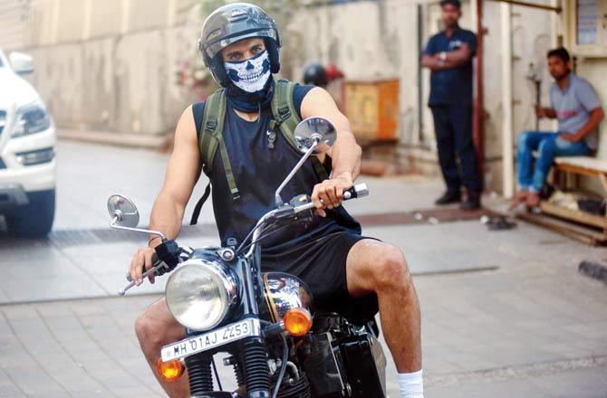 Actor Aditya Roy Kapur wears a mask while riding out of a gym complex in Bandra. Pic/Atul Kamble