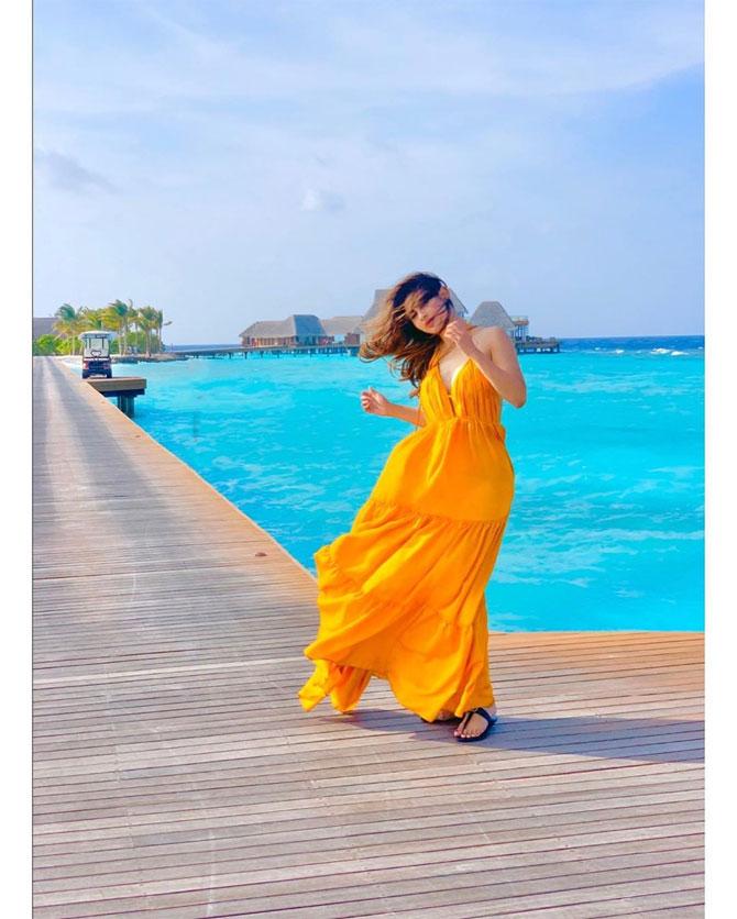 Mouni Roy looks smashingly attractive in this yellow gown. As the wind blew her hair, she flirted with the camera to give that one perfect shot that makes the actress highly desirable.