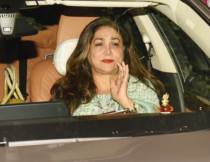 In photo: Tina Ambani tries to hide her face as the paparazzi makes an attempt to get a glimpse of the former actress.