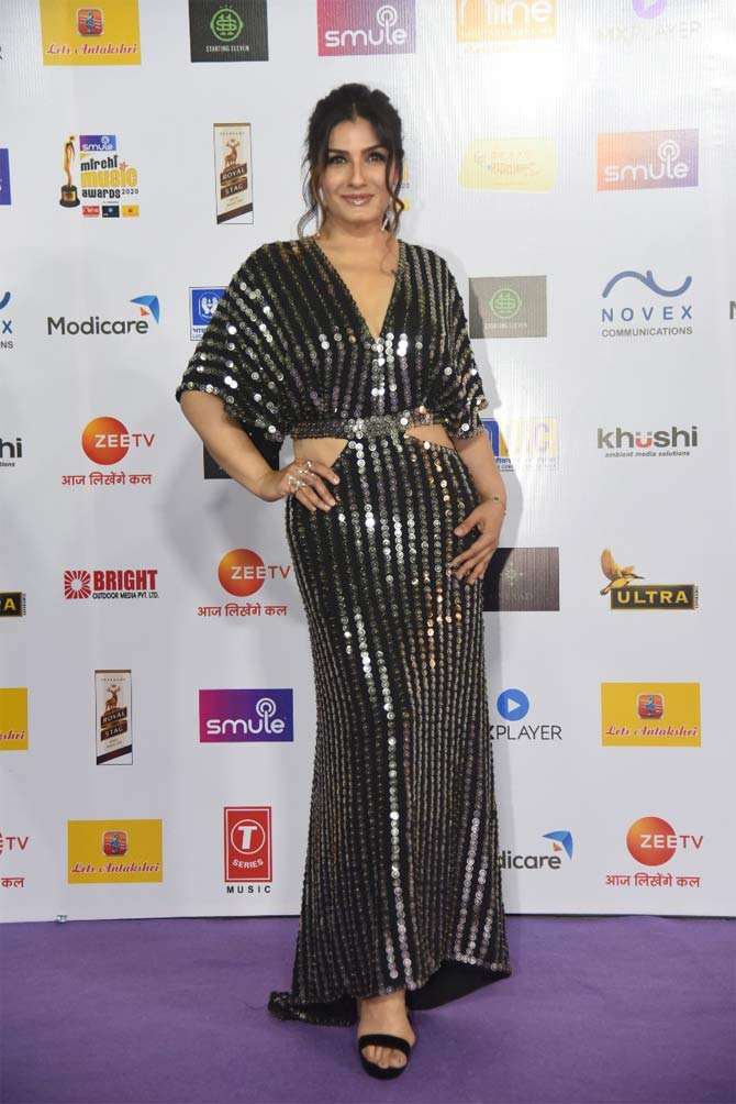 Raveena Tandon stunned in a black gown with vertical sequin design. 