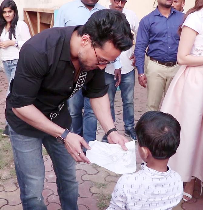 Tiger Shroff was obliged for photos and even signed the picture for the young fan.