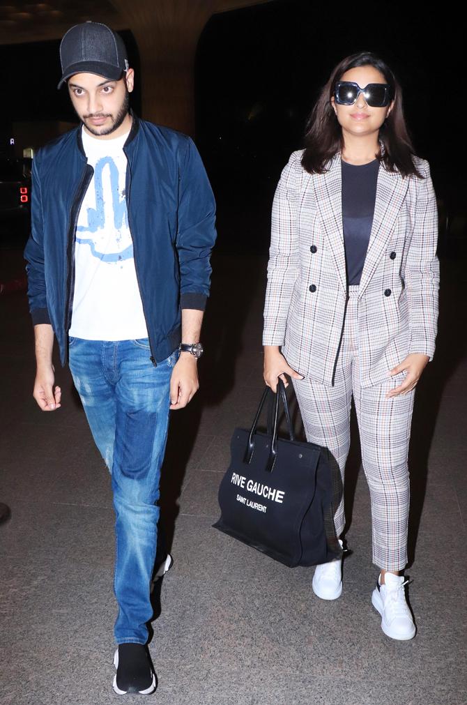 Parineeti Chopra was clicked with her brother Shivang Chopra at Mumbai Airport. The actress was seen in a striped black and white formal pant and coat, paired with a blacktop.