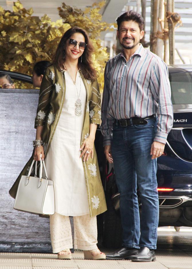We did a double-take seeing his lean frame and new look in the video shared by Mads. Seeing the good doctor match steps with her looks like there is an actor in waiting. We won't be surprised if he acts in one of their productions.
In picture: Madhuri Dixit and husband Shriram Nene pose for the photographers at the Bandra restaurant.