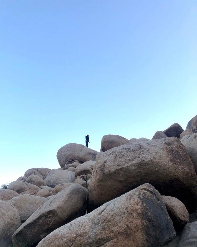In photo: Ananya Birla treks on the rocks during her camping adventure trip.

