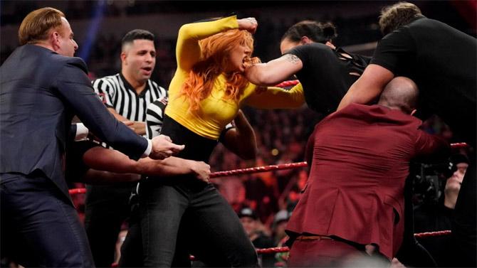 As Becky Lynch entered the ring, she and Shayna Baszler began hitting blows at each other with the WWE officials breaking them apart
