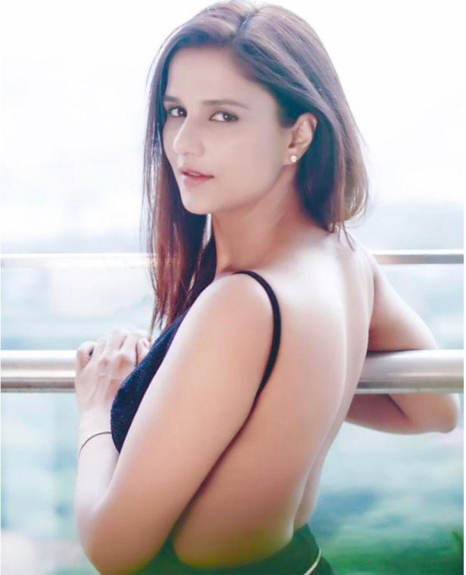 Shipra wore a backless top as she posed on the railing. 