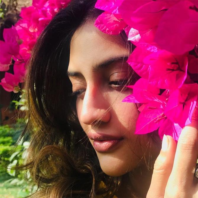 In photo: Nusrat Jahan caught in a candid moment as she gets playful with Bougainvillea flowers.



