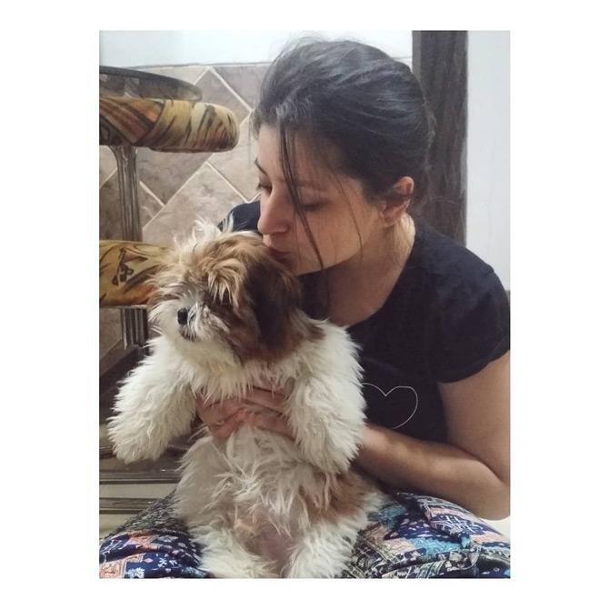 In photo: Natasha Gandhi showers a pet with unconditional love as she shows off her witty side once again. She writes: Do not leave your puppies unattended, I WILL run away with them!




