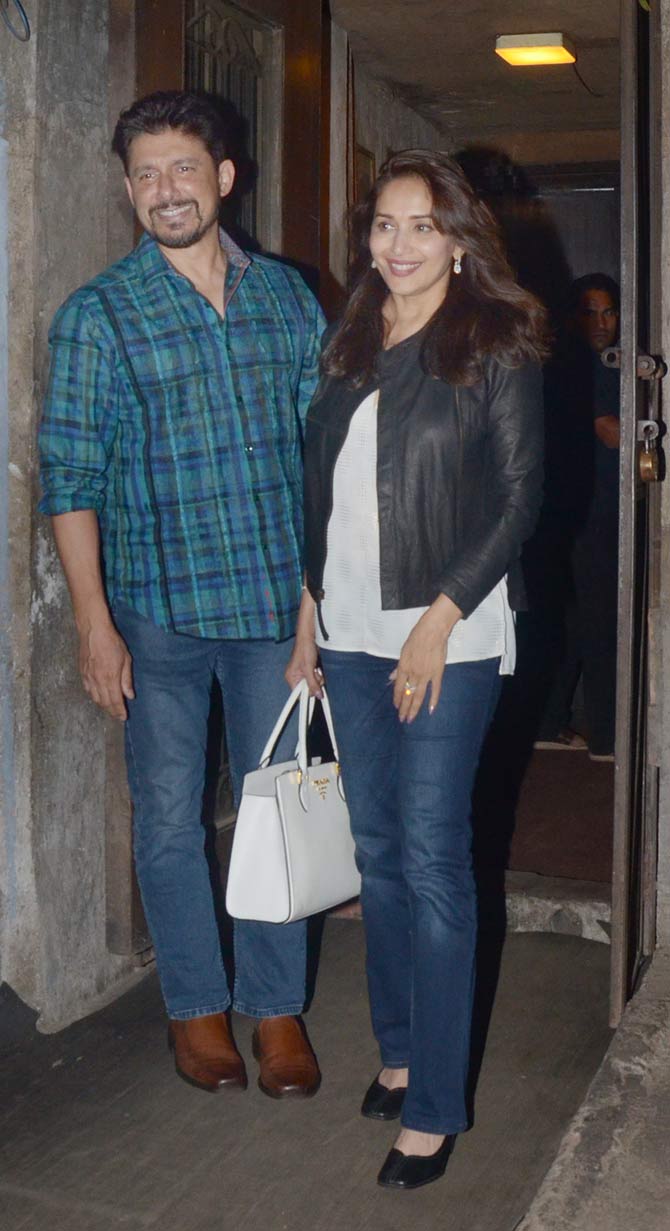 Madhuri Dixit Nene along with husband Shriram Nene was out enjoying dinner at a popular restaurant in Bandra, Mumbai. The couple was all smiles as they posed for the photographers while they exited the eatery. All pictures/Yogen Shah