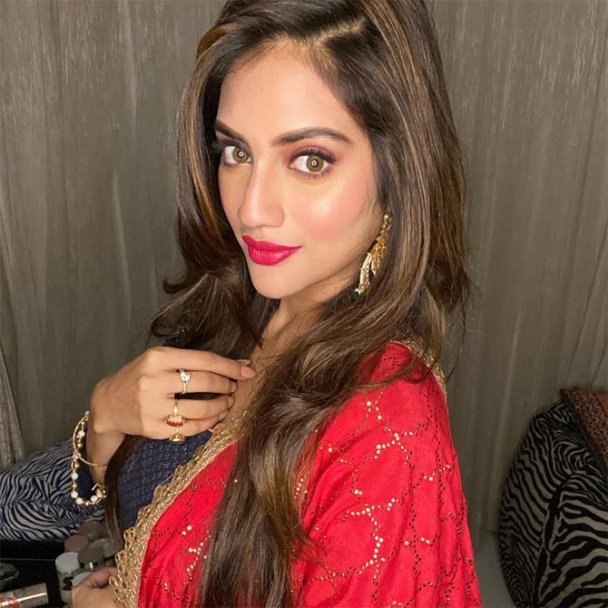 In this photo, Nusrat Jahan stuns in a salwar suit with red dupatta as she poses for the lenses