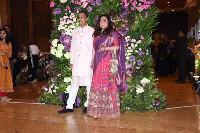 For the grand wedding reception, Tina Ambani was all decked up in a beautiful lehenga choli in pink and blue. She complimented her outfit with pink lipstick, minimal accessories and left her beautiful long tresses open, while Anil Ambani looked suave in a pink kurta pajama
