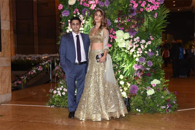 The 38-year-old philanthropist opted for an intricately designed golden lehenga choli and paired it with a black hand clutch. Natasha completed her look by draping her dupatta over her back. With dewy makeup and minimal accessories, Natasha left her coloured tresses parted on one side