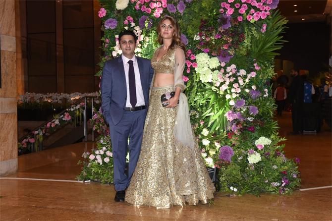 While Natasha looked stunning in lehenga choli, Adar Poonawalla looked suave in a navy blue tuxedo. Both Natasha and Adar Poonawalla were seen posing for the shutterbugs as they came to bless the newly married couple