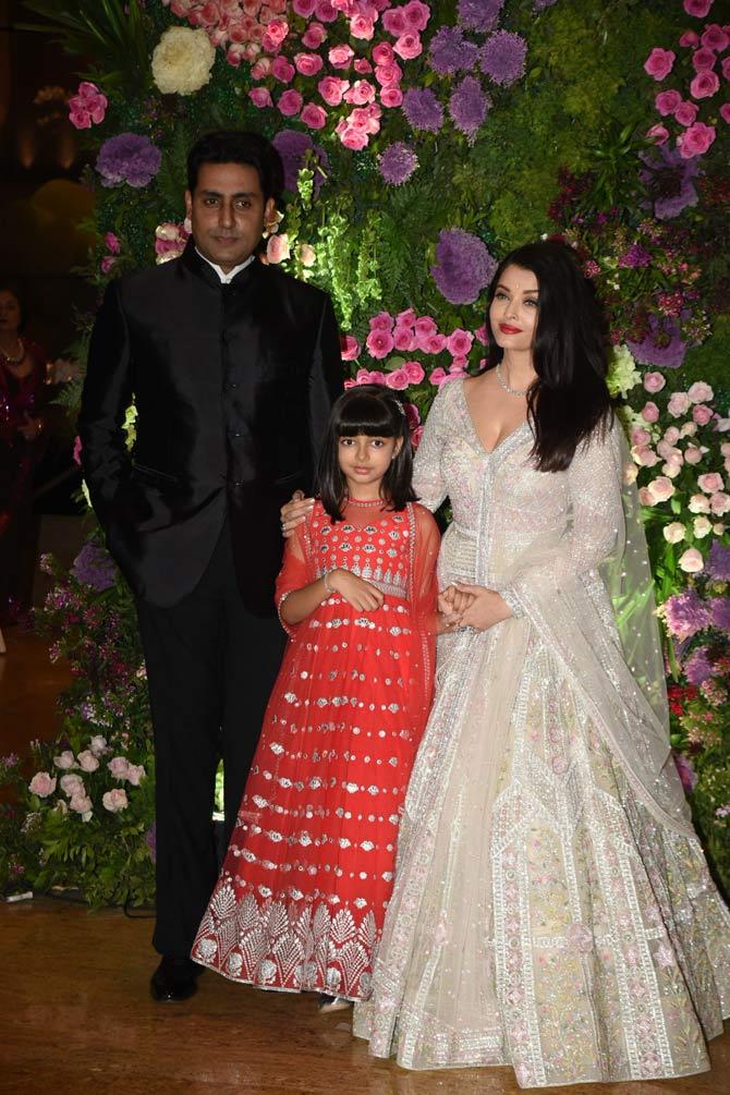 While Abhishek Bachchan opted for a black suit with a Modi jacket, Aishwarya Rai Bachchan was a sight to behold in a white and silver lehenga. Little Aaradhya also stood out in a red Anarkali that she opted for the reception hosted in the city.