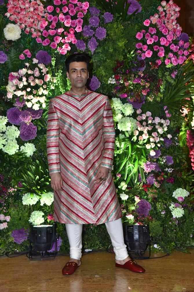 Karan Johar posed for the shutterbugs as he walked into Armaan Jain and Anissa Malhotra's reception ceremony.
