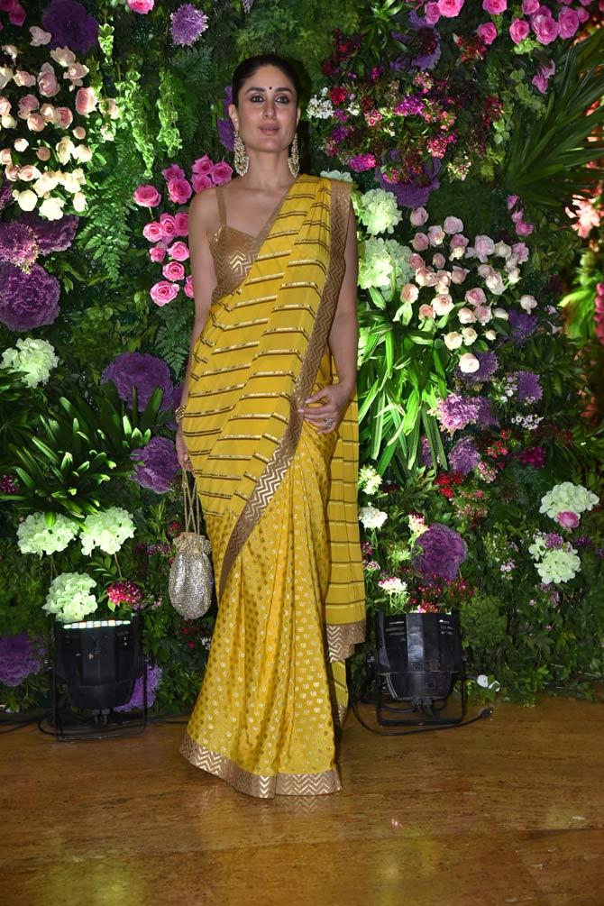 Kareena Kapoor Khan sizzled in a yellow saree. Kareena's striped saree, with a contrast blouse, looked no less than a perfect reception outfit.