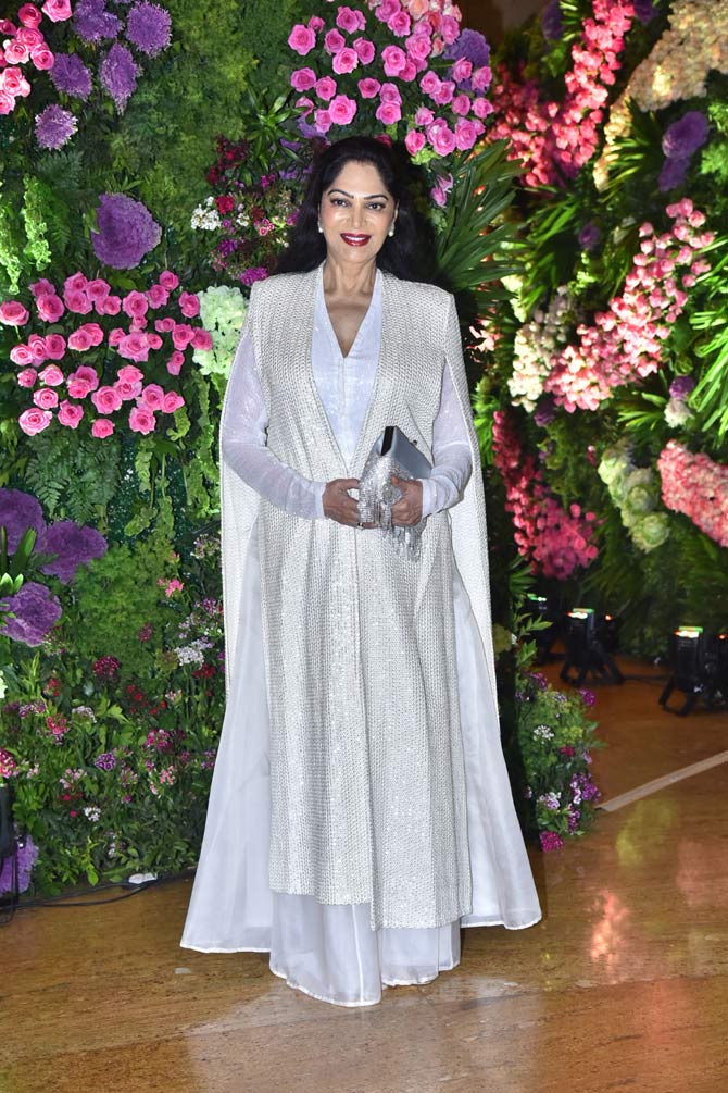 Simi Garewal was all smiles as she walked into the reception ceremony wearing a white outfit.