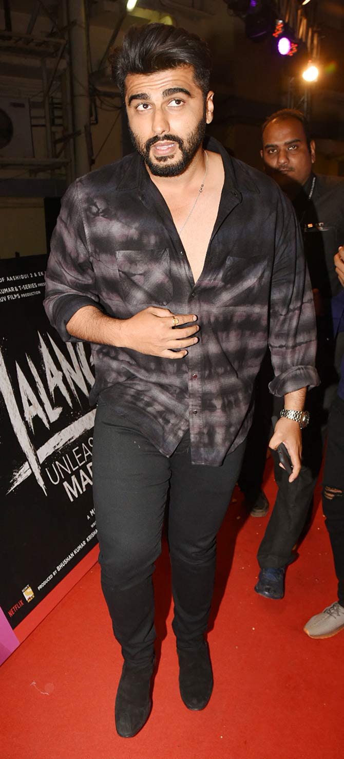 Arjun Kapoor was snapped wearing a checkered ombre shirt, paired with black denim at the red carpet event of Malang.