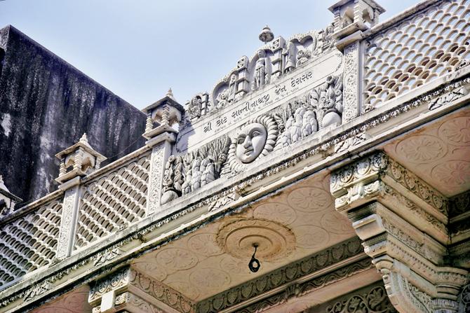 Details of pediment atop the derasar that includes its year of establishment. This place of worship stands cheek-by-jowl beside commercial or residential sites, offering an idea of how very little has changed