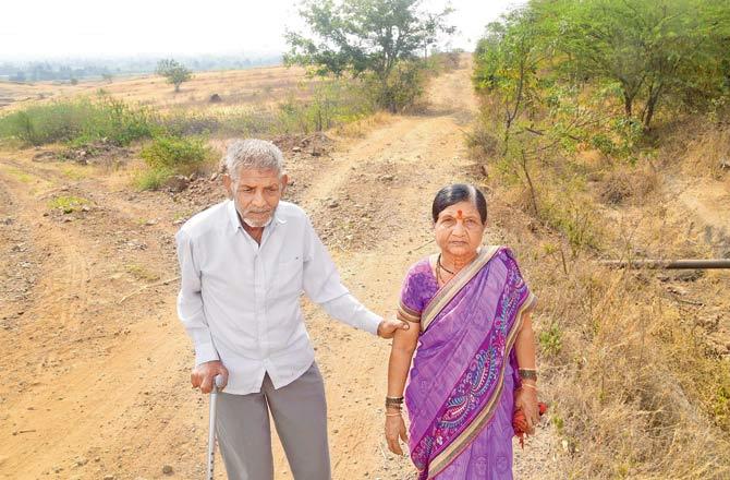 Hindurao Ingale with his wife and family at his home in Satara