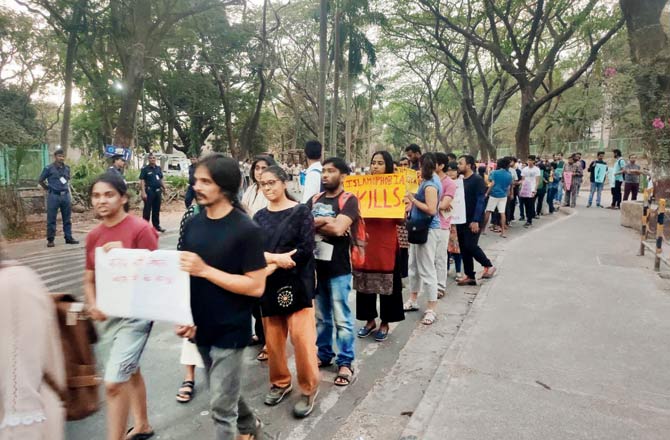 IIT-Bombay students display placards during their peace march on Wednesday