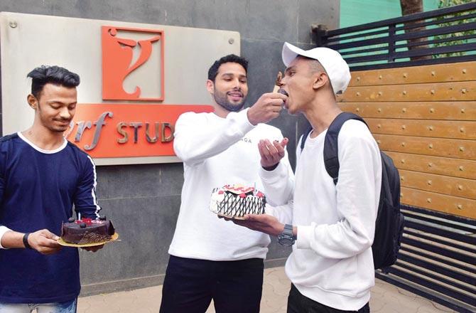 Siddhant Chaturvedi cut cakes brought for him by lensmen, to mark a year since the release of Gully Boy