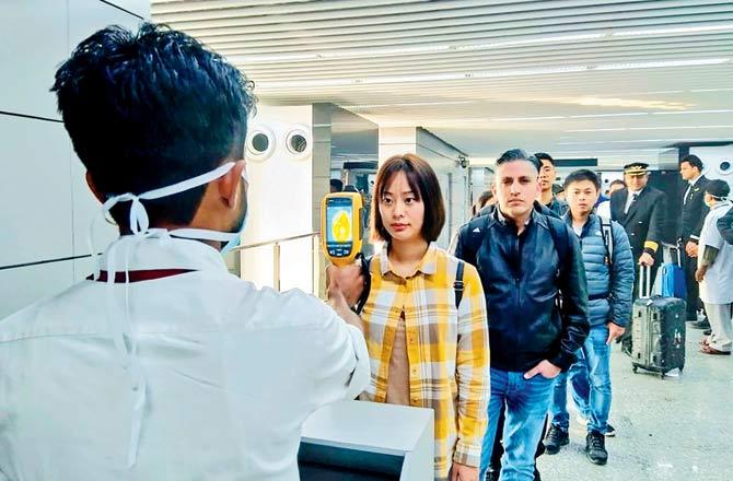 Passengers arriving from China and Hong Kong are screened for Coronavirus at Kolkata-s Netaji Subhash Chandra Bose International Airport. Pic/AFP 