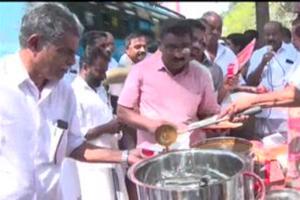Cong workers distribute beef curry in front of police station in Kerala