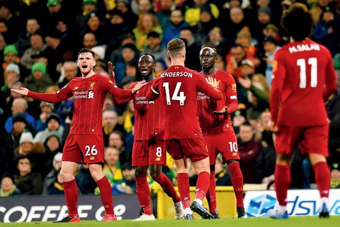 Liverpool players celebrate Mane’s  all important strike; (below) Liverpool manager Jurgen Klopp celebrates the 1-0 win against Norwich City