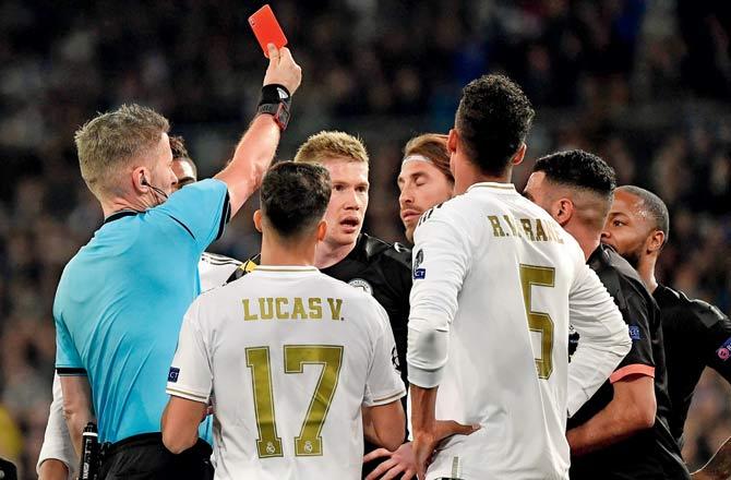 Real Madrid captain Sergio Ramos (fourth from left) is shown the  red card for a foul on Manchester City striker Gabriel Jesus. Pic/AFP