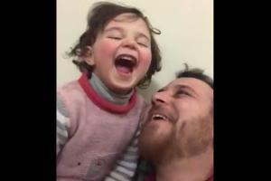 Syrian dad teaches daughter to laugh aloud at sound of bombing