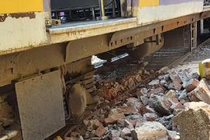 Passengers have narrow escape after excavator brings down fencing wall