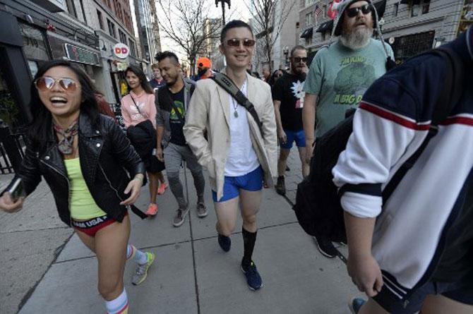 Bostonians in their underwear parade down Boylston Street after getting off of the subway at Copley Square during the annual No Pants Subway Ride in Boston, Massachusetts on January 12, 2020.